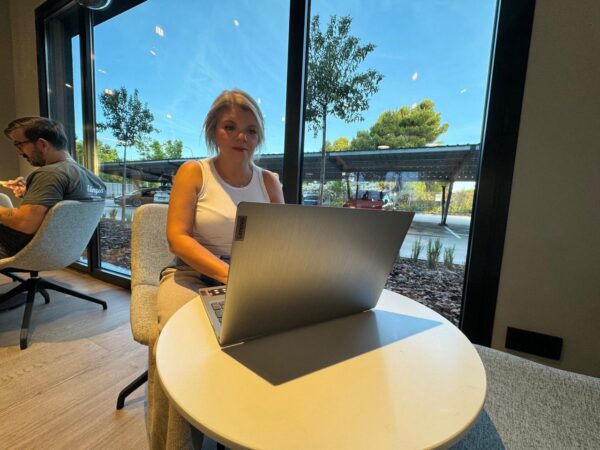 Ka, coach de bienestar online, dirigiendo una sesión de coaching en línea en un ambiente tranquilo y profesional